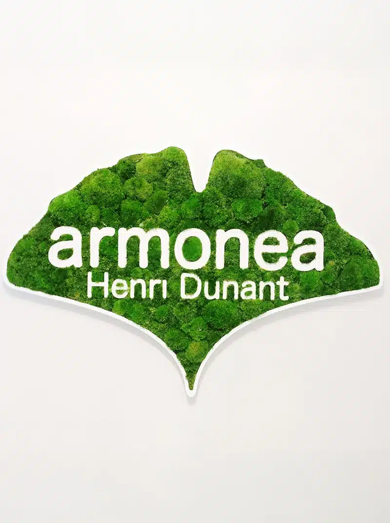 Logo-ul Armonea Henri Dunant pe fond verde