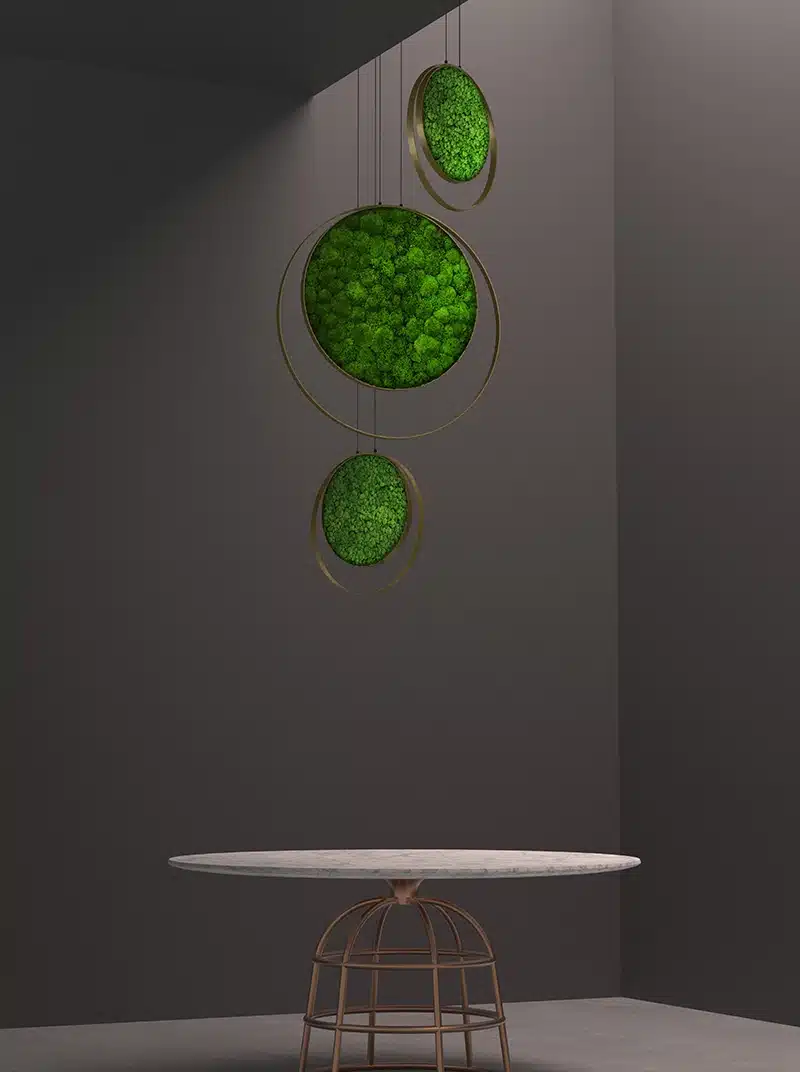 Modern green decor on gray wall above round table.